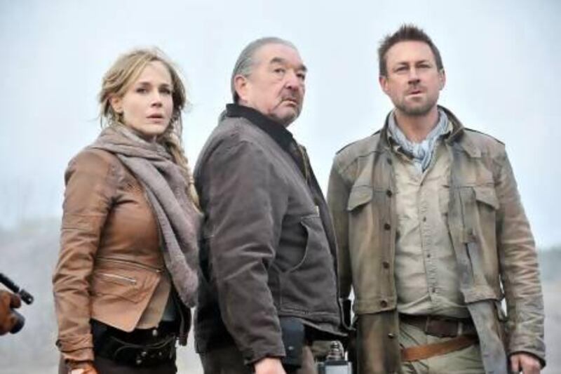From left, Julie Benz, Graham Greene and Grant Bowler in an episode from Defiance. Ben Mark Holzberg / Syfy / AP Photo