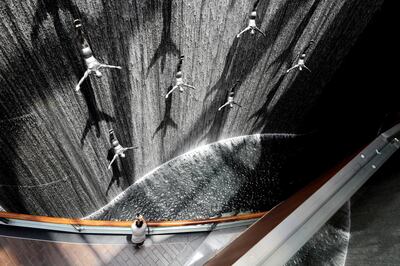 Dubai, United Arab Emirates - July 20, 2019: Standalone. A visitor takes pictures of The Dubai Mall Waterfalls. Saturday the 20th of July 2019. Downtown, Dubai. Chris Whiteoak / The National