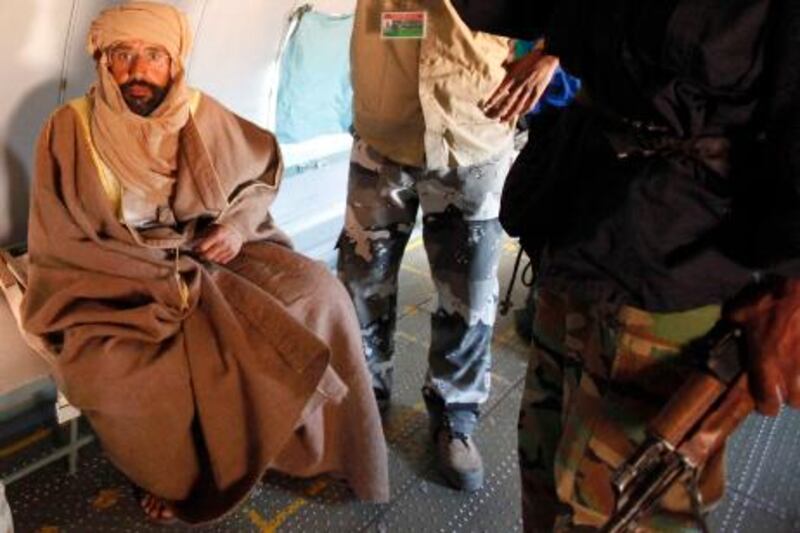 Saif al-Islam Gaddafi is pictured sitting in a plane in Zintan November 19, 2011. Saif al-Islam Gaddafi told Reuters on Saturday that he was feeling fine after being captured by some of the fighters who overthrew his father and he said injuries to his right hand were suffered during a NATO air strike a month ago. REUTERS/Ismail Zitouny (LIBYA - Tags: POLITICS CIVIL UNREST TPX IMAGES OF THE DAY) *** Local Caption ***  ISM01_LIBYA-SAIF-WE_1119_11.JPG