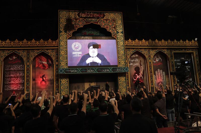 Supporters of the Lebanese Shiite Hezbollah movement gather to watch the transmission on a large screen of a speech by the movement's leader Hasan Nasrallah in the Lebanese capital Beirut's souther suburbs on August 31, 2019.  Nasrallah said today y his Lebanese movement's response to a recent drone attack on the group's Beirut stronghold had been "decided". / AFP / ANWAR AMRO
