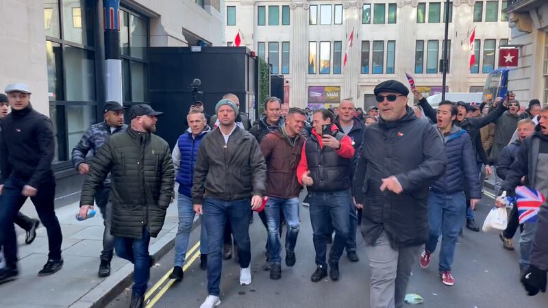 Far-right activist Tommy Robinson with counter-protesters in London's Chinatown. PA