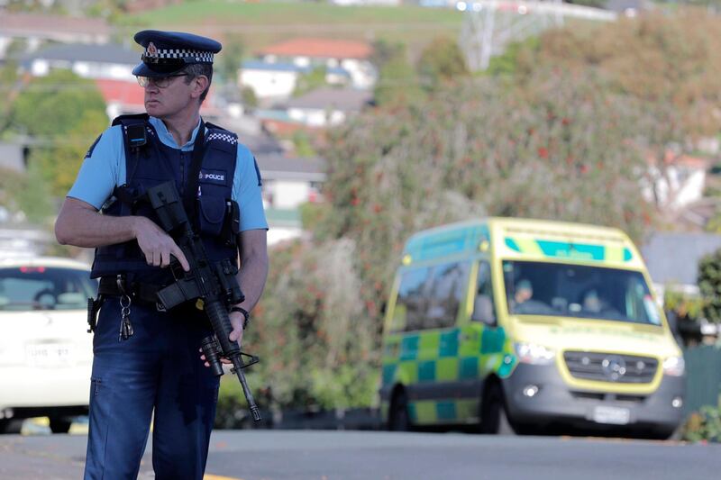 Armed police stands at the scene of a shooting incident following a routine traffic stop in Auckland. New Zealand Herald via AP