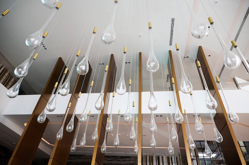 In keeping with the water theme, droplet-shaped light fixtures hang in the lobby area 