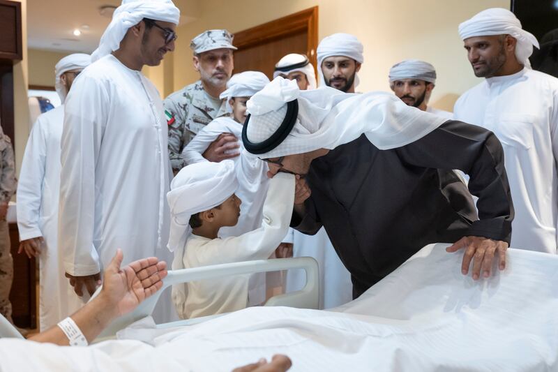 A boy is greeted by Sheikh Mohamed at the hospital