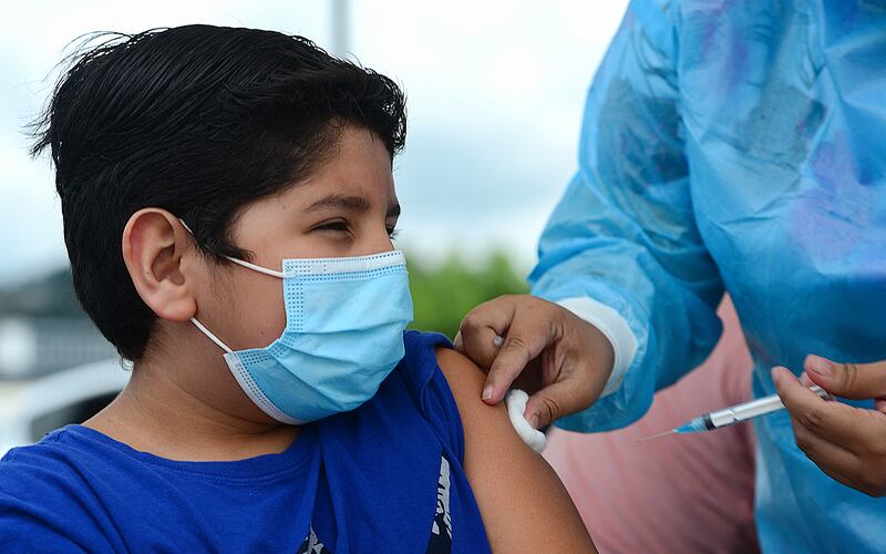 A boy receives the first dose of the Pfizer/BioNTech Covid-19 vaccine in Tegucigalpa during a vaccination programme for teens aged 12 to 15.  AFP