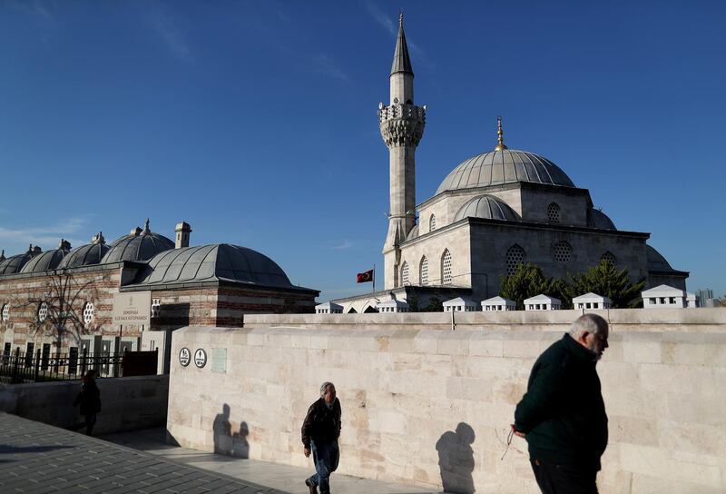 People walk in front of the Semsi Pasha Mosque on sunny day in Istanbul, Turkey. EPA