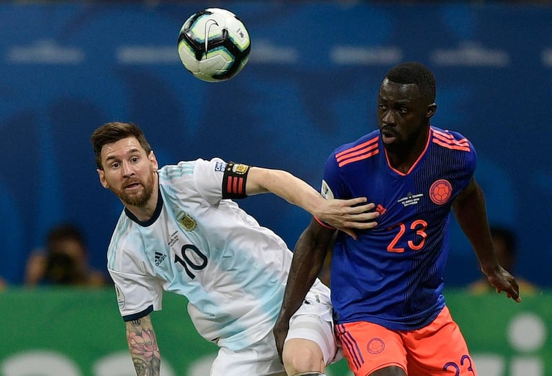Argentina's Lionel Messi, left, and Colombia's Davinson Sanchez vie for the ball. AFP