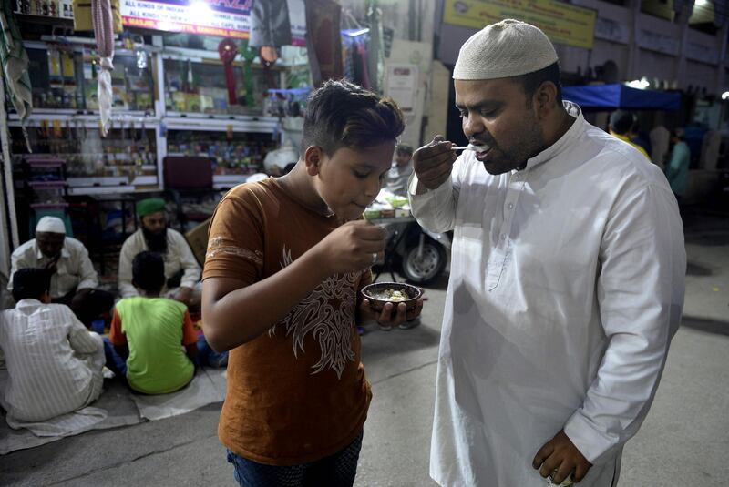 Indian Muslims break their fast outside a mosque in Hyderabad. AFP