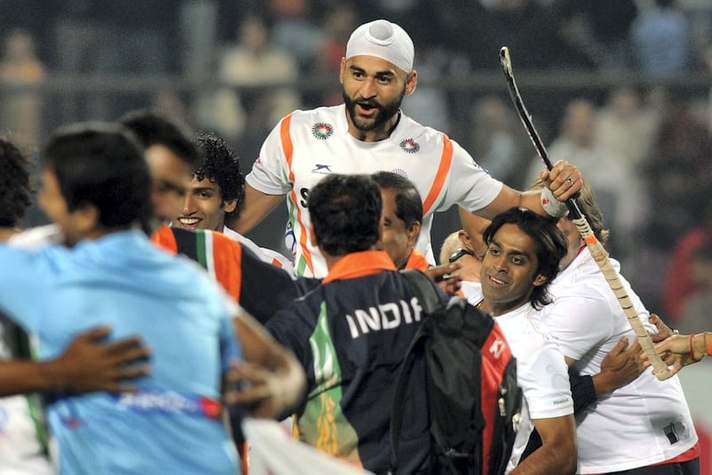 Hockey team members lift player Sandeep Singh of India after winning the men's field hockey match between India and France for the final position of the FIH London 2012 Olympic Hockey qualifying tournament at the Major Dhyan Chand National Stadium in New Delhi on February 26, 2012.   AFP PHOTO/Indranil MUKHERJEE / AFP PHOTO / INDRANIL MUKHERJEE