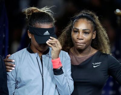 FILE - In this Sept. 8, 2018, file photo, Naomi Osaka, left, of Japan, is hugged by Serena Williams after Osaka defeated Williams in the women's final of the U.S. Open tennis tournament in New York. The tenor of the final between Williams and champion Osaka, whose terrific performance was largely ignored amid the chaos that enveloped Arthur Ashe Stadium, began to shift after chair umpire Carlos Ramos warned Williams for receiving coaching signals. (AP Photo/Julio Cortez, File)