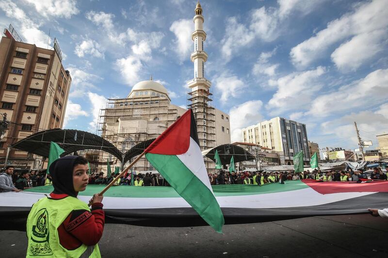 Protesters hold together a giant Palestinian flag during a demonstration against US President Donald Trump's Middle East peace proposal in Khan Yunis in the southern Gaza Strip. AFP