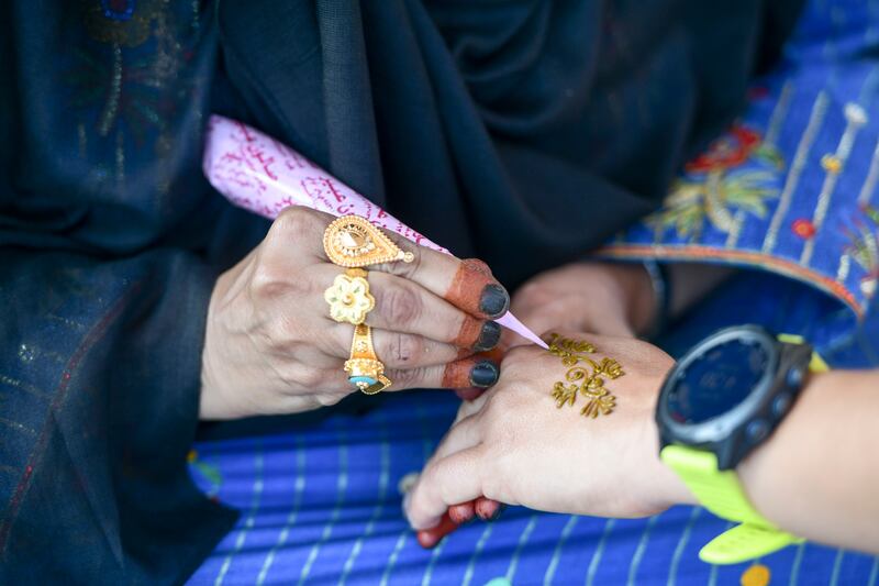A woman applies henna