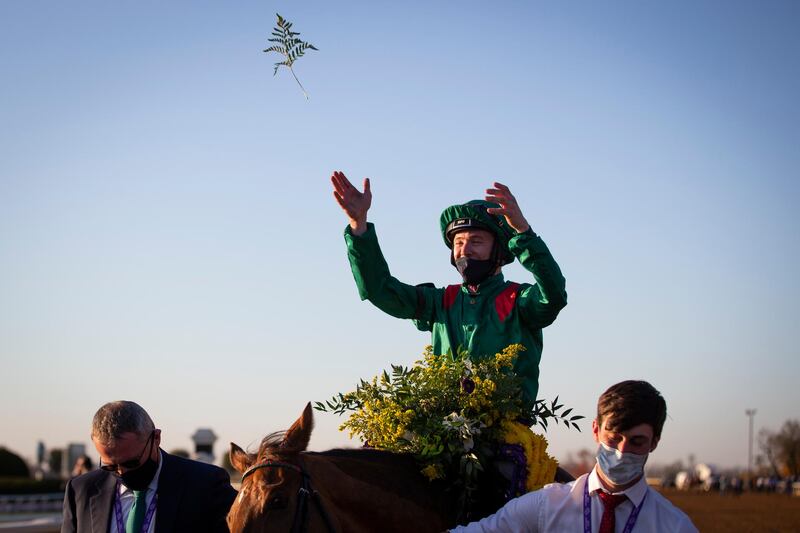 Jockey Christophe Soumillon throws flowers after Tarnawa won the Longines Breeders' Cup Turf race. USA Today