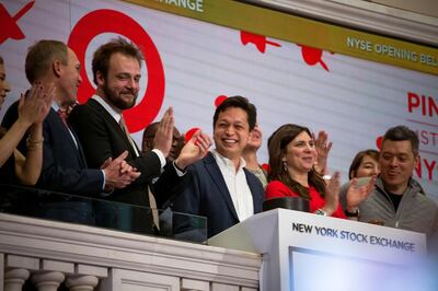 Evan Sharp, co-founder and chief creative officer of Pinterest Inc., second left, and Ben Silbermann, co-founder and chief executive officer of Pinterest Inc., center, ring the opening bell on the floor on the New York Stock Exchange (NYSE) during the company's initial public offering (IPO) in New York, U.S., on Thursday, April 18, 2019. Pinterest's message to investors was don't compare us to social media or a search engine. The outcome Wednesday was that it raised about $1.4 billion in an above-range initial public offering. Photographer: Michael Nagle/Bloomberg