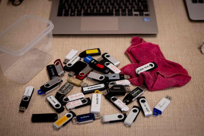 Flash drives with various operating system setups are seen on a workbench at Catbytes. AFP
