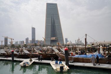 The Kuwait Central Bank towers are pictured over the traditional Dhow harbor. The banking regulator has allowed lenders to distrubute cash dividends for 2020. Reuters.