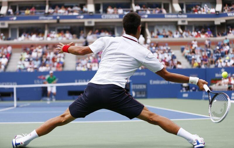 Novak Djokovic returns a shot against Sam Querrey during their US Open third round match on Saturday. Matt Rourke / AP / August 30, 2014 ,