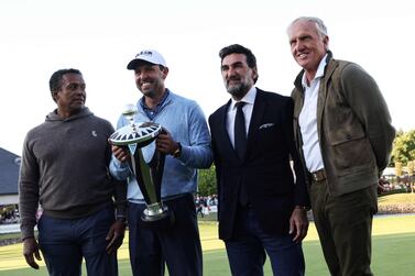 First-placed and winner South African golfer Charl Schwartzel (2nd L) celebrates with the trophy as he poses with CEO of LIV Golf Greg Norman (R) and Yasir Al-Rumayyan (2nd R) at the end of the third and final day of the LIV Golf Invitational Series event at The Centurion Club in St Albans, north of London, on June 11, 2022.  - The LIV Golf Invitational London, the launch event of a lucrative and divisive series that is rocking the sport reaches it's conclusion.  The $25 million event in St Albans -- the biggest prize pot in history -- is the first of eight tournaments this year bankrolled by Saudi Arabia's sovereign wealth fund, worth a combined $255 million.  (Photo by Adrian DENNIS  /  AFP)