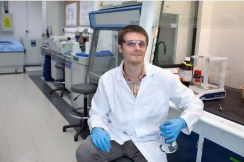 Physicist and a researcher Matt Martin, who studies the use of gold nanoparticles, pat the Khalifa University in Abu Dhabi.
Silvia Razgova / The National