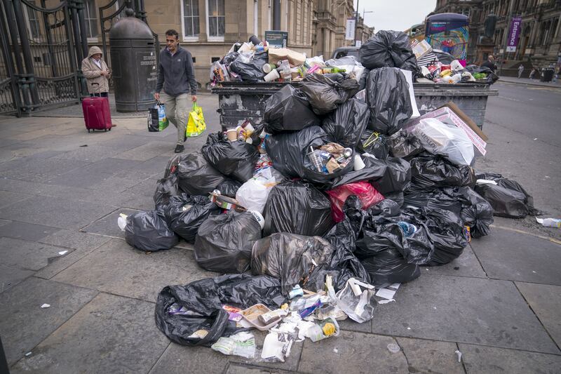 Bins overflow and litter piles up on Chambers Street as cleansing workers from the City of Edinburgh Council are on the fourth day of eleven days of strike action. PA