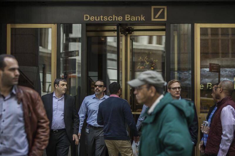 People exit Deutsche Bank AG headquarters on Wall Street in New York, U.S., on Thursday, April, 26, 2018. Deutsche Bank AG is planning to cut more than 10 percent of U.S. jobs as it withdraws from businesses where it can't compete, a person briefed on the matter said. Photographer: Victor J. Blue/Bloomberg