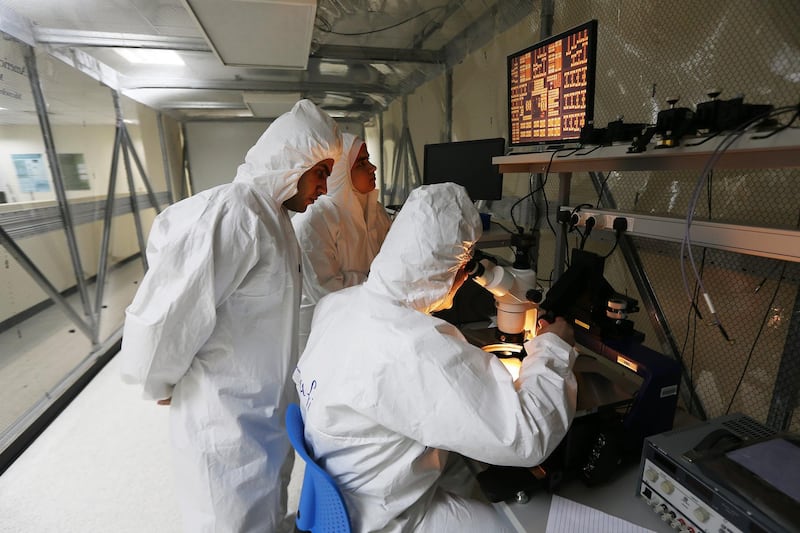 SHARJAH , UNITED ARAB EMIRATES Ð April 6 , 2015 : Lutfi Albasha , Associate Professor , Electrical Engineering  ( center ) with Mansour Taghadosi ( 1st left )  and Eiman Elghanam ( center ) students of Electrical Engineering doing research on energy harvesting in the clean room at Microwave Imaging and Nondestructive Evaluation Laboratory at American University of Sharjah in Sharjah. ( Pawan Singh / The National ) For News. Story by Melanie Swan
 *** Local Caption ***  PS0604- AUS RESEARCH04.jpg