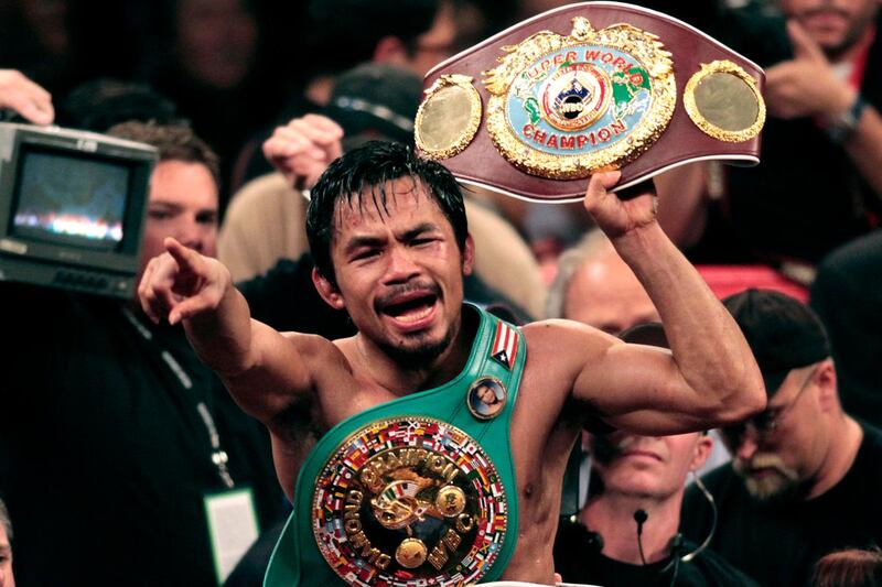 Manny Pacquiao, of the Philippines, holds the championship belt at the finish of his WBO welterweight boxing title fight against Miguel Cotto, of Puerto Rico, Saturday, Nov. 14, 2009 in Las Vegas. Pacquiao won the fight by TKO in the 12th round. (AP Photo/Isaac Brekken)