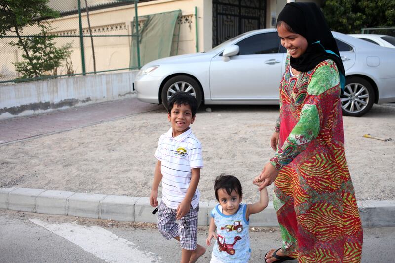 August 16 2011- Shahama, UAE - Lina Aliyata (31) from Cagayan, Phillipines takes her employer's children (Abdelaziz, 1 and Abdulrahman 6) out for a short walk around the block half an hour prior to Iftar. "I love living in Shahama, I've made many friends here" she says. (Razan Alzayani/ The National) 
