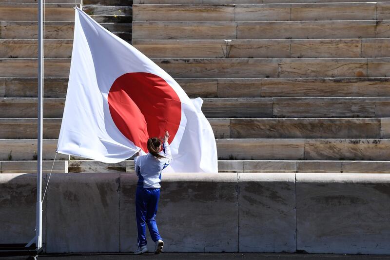 An athlete by the Japanese flag. AFP