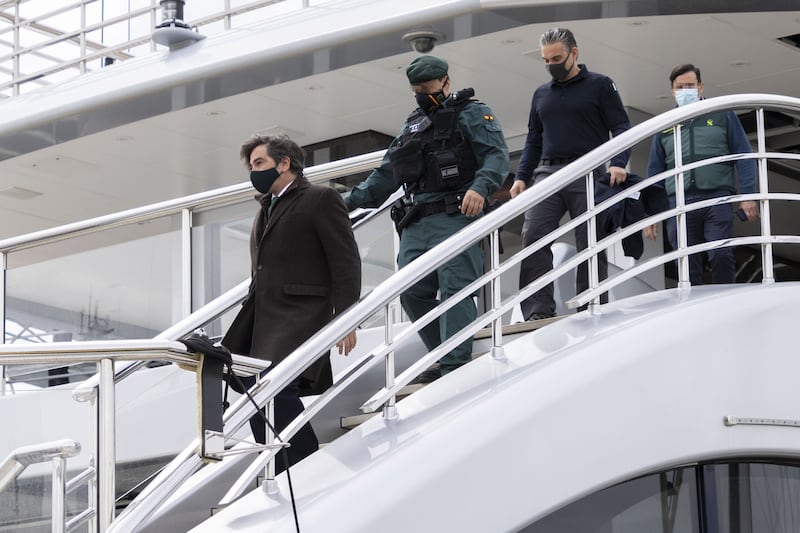 The unidentified prosecutor of the case disembarks 'Tango', followed by Spanish civil guards and US federal agents, in Palma de Mallorca. EPA