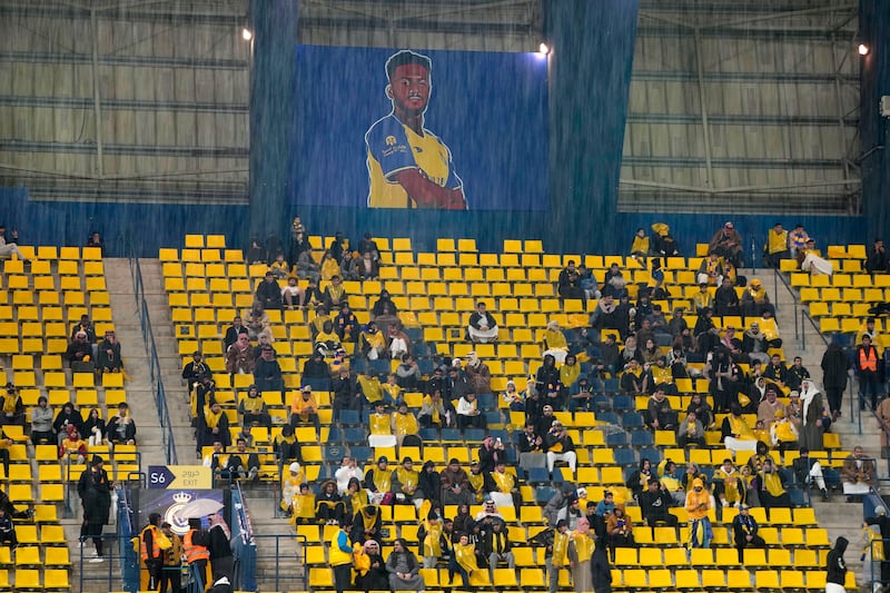 Al Nassr fands watch the game on Friday despite heavy rain. AP