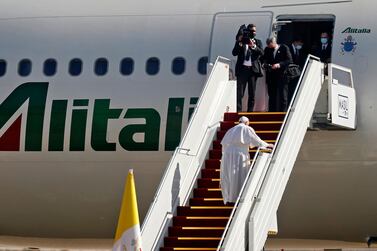 Pope Francis climbs the steps to board his Alitalia Airbus A330 aircraft, as he departs from the Baghdad International Airport following a historic visit to Iraq. AFP 