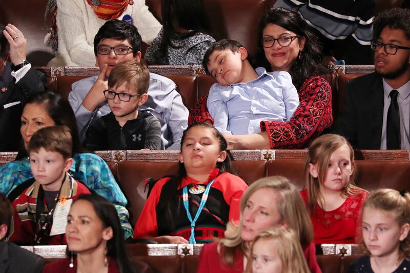 U.S. Representative Rashida Tlaib (D-MI) (TOP R) holds a sleeping child as the U.S. House of Representatives meets for the start of the 116th Congress. Reuters