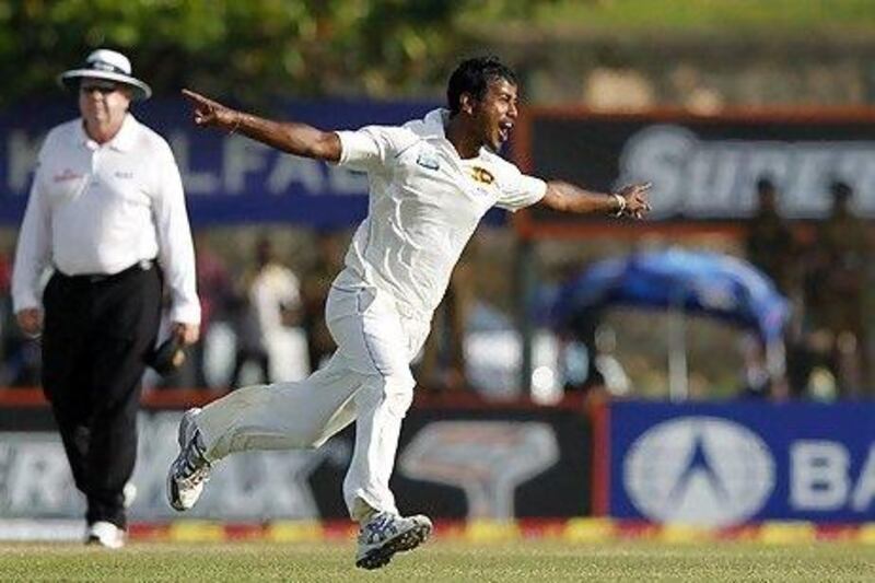 Sri Lanka's Nuwan Kulasekara celebrates taking the wicket of Pakistan's captain Mohammad Hafeez during the third day of their first test match in Galle.