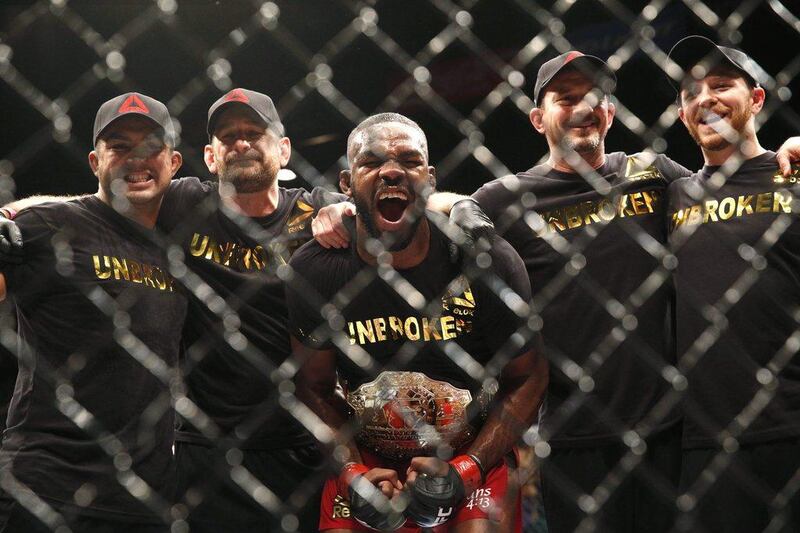 Jon Jones celebrates while posing with his corner after defeating Daniel Cormier to defend his light heavyweight title at UFC 182 in Las Vegas on Saturday. John Locher / AP