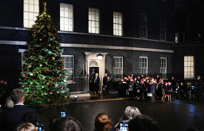 Boris Johnson switches on the Christmas tree lights outside 10 Downing Street in London, December 1. EPA