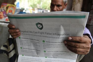 An Indian newspaper vendor reading a newspaper with a full back page advertisement from WhatsApp intended to counter fake information, in New Delhi last July after fake information sparked mob lynching attacks across the country. AFP