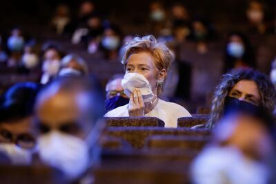 FILE - Actress Tilda Swinton wears a mask as she sits in the auditorium during the opening ceremony of the 77th edition of the Venice Film Festival in Venice, Italy, on Sept. 2, 2020. This year, three of the four major fall film festivals, including Venice, are going forward despite the pandemic. Those in Venice acknowledge it hasnâ€™t been anywhere near the same. Masked moviegoers in set-apart seats. A barrier walls off the red carpet to discourage crowds of onlookers. Greetings are kiss-less. A little bit of the romance of movies has gone out. (AP Photo/Domenico Stinellis, File)