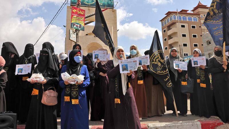 Supporters of the Islamic Jihad movement distribute sweets to celebrate the escape of six Palestinians from an Israeli prison, in Rafah in the southern Gaza Strip.   Six Palestinians broke out of an Israeli prison through a tunnel dug beneath a sink, triggering a massive manhunt for the group that includes a prominent ex-militant.   AFP