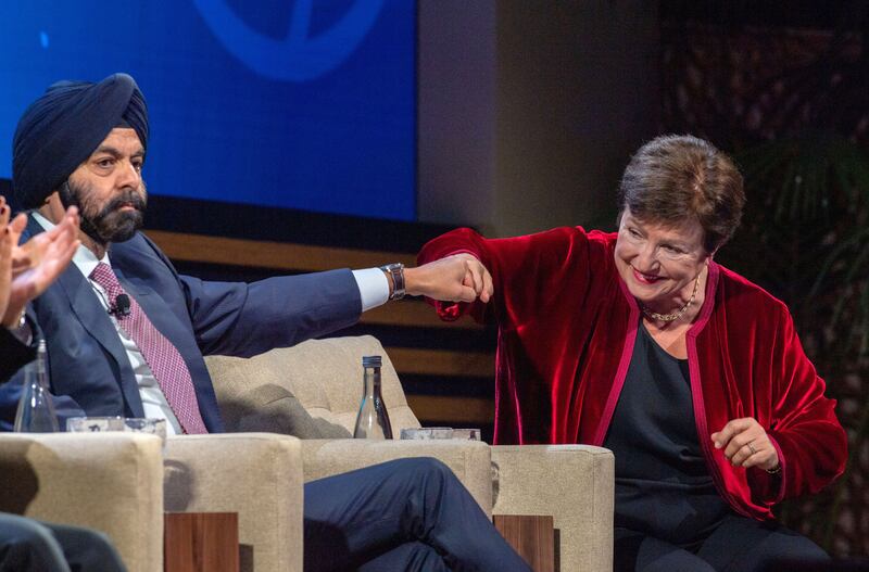 The World Bank's Ajay Banga and the IMF's Kristalina Georgieva fist-bump during a panel discussion in Marrakesh. EPA