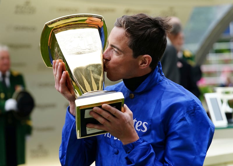 Jockey James Doyle kisses the trophy after winning the Platinum Jubilee Stakes on Naval Crown. PA 