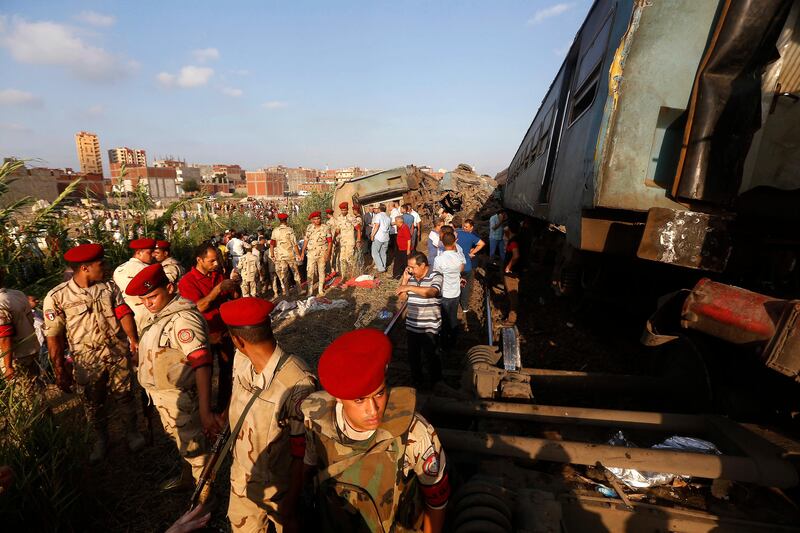 Army attend the scene of a train collision just outside Egypt’s Mediterranean port city of Alexandria. Ravy Shaker / AP Photo