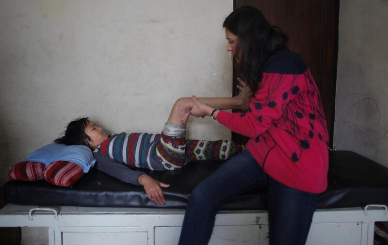 Sunmaya Tamang, a survivor of the April 25 earthquake, receives physiotherapy at a rehabilitation center in Kathmandu, Nepal. Niranjan Shrestha / AP Photo