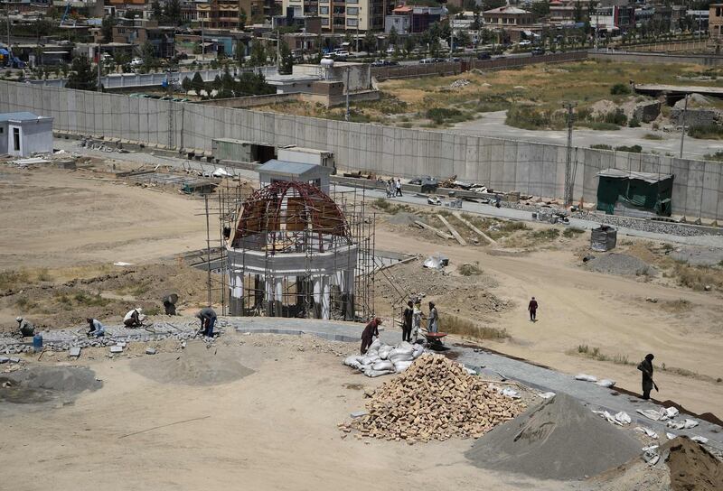 Workers prepare a pathway past a gazebo on the Darulaman Palace grounds in Kabul. AFP