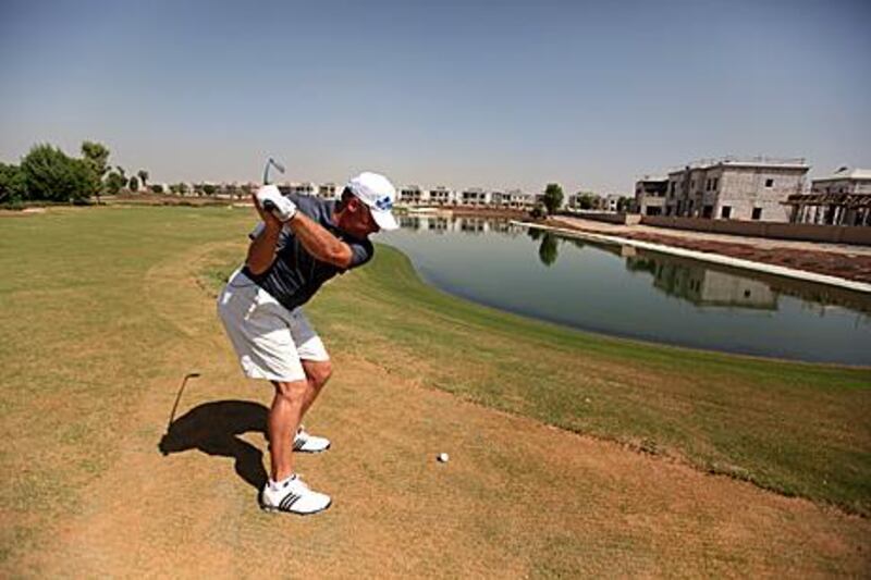 Wayne Johnson, the Earth Course resident professional, sizes up a shot.