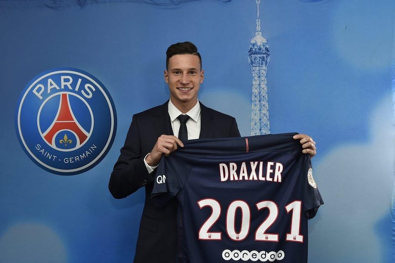 Julian Draxler poses with the PSG jersey at a news conference to announce his four-and-a-half year contract with the French club on January 3, 2017. EPA handout