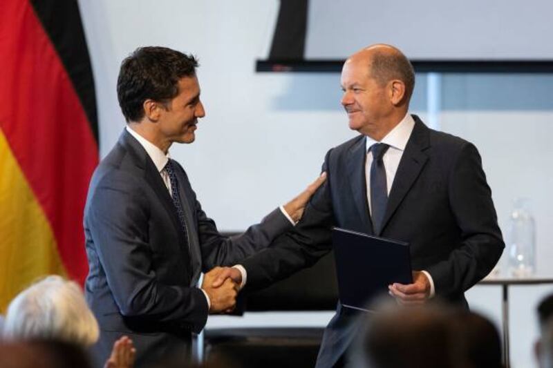 Canada's Prime Minister Justin Trudeau (L) shakes hands with German Chancellor Olaf Scholz during the Canadian-German Business Forum in Toronto. Getty Images