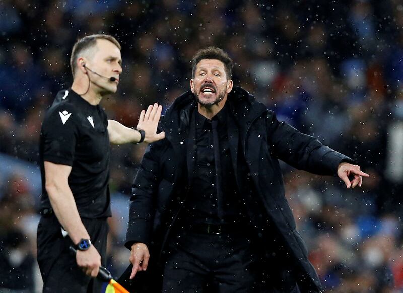 Atletico Madrid manager Diego Simeone argues with a linesman. Reuters