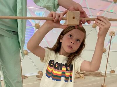 Indiana, 9, gets creative in the Build Lab, where an array of poles and brackets encourage creativity and design, and children are rewarded with a 'rain' shower. Photo: Gemma White for The National