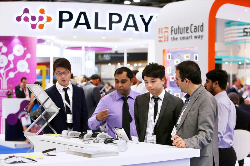 The push to digitise banking in the UAE came after the global financial crisis in 2008. Above, visitors at the Cards & Payments show in Dubai. Pawan Singh / The National